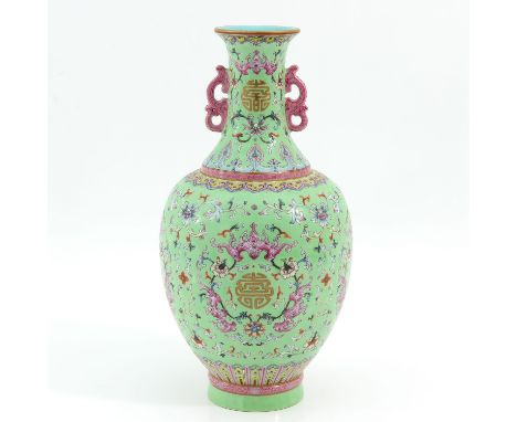 Light green ground with Famille Rose enamels in floral decor with bats, Qianlong mark, 33 cm. tall. 