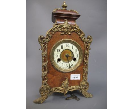 19th Century oak mantel clock, the arched top with turned finial with a gilt brass and silvered dial with Roman numerals and 
