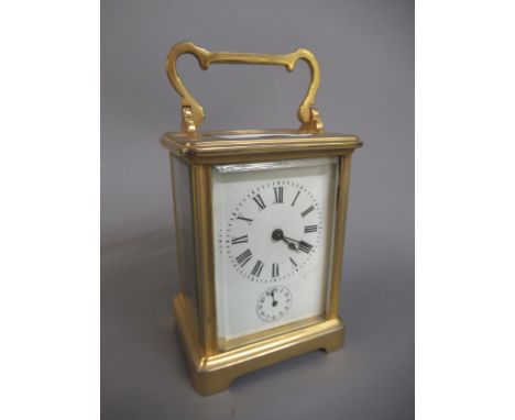 Small brass cased carriage clock, the enamel dial with Roman numerals and subsidiary alarm dial, the single train movement wi