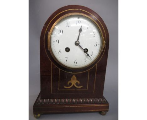 Edwardian mahogany and inlaid mantel clock having circular enamel dial with Arabic numerals on low brass feet and an Edwardia