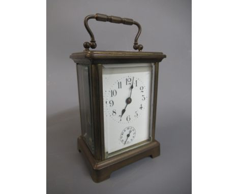 Small brass cased carriage clock with enamel dial, Arabic numerals and subsidiary alarm dial, the single train movement with 