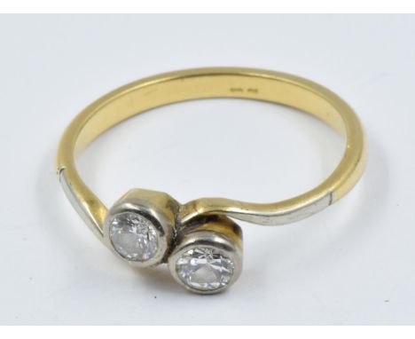 Yellow gold two stone diamond set ring in crossover stlye 