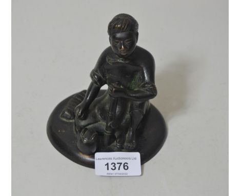 Small oriental dark patinated bronze of a seated figure with teapot and pipe, signed to base, 4.75ins high 