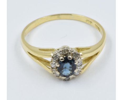 18ct Yellow gold oval sapphire and diamond cluster ringThis is a modern ring in 'as new' condition, centre stone approximatel