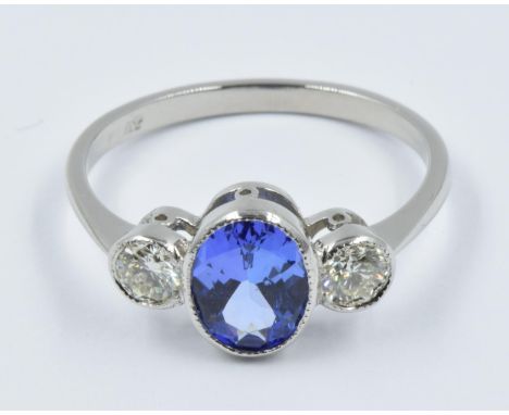 Platinum ring set with an oval central tanzanite flanked by two diamondsThis is a modern ring in 'as new' condition, centre s