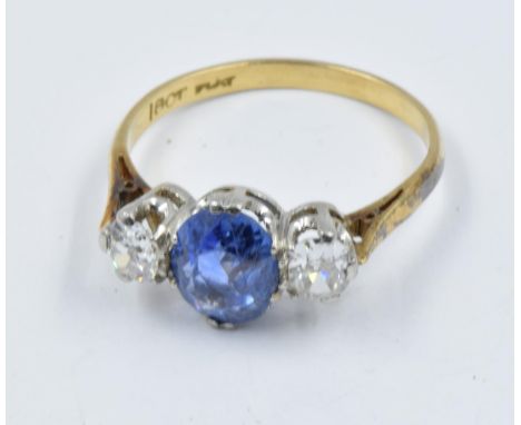 18ct Gold and platinum three stone sapphire and diamond ring, the central sapphire approximately 8mm x 6mmMid 20th Century ri