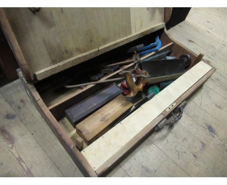 Carpenters tool trunk containing various woodworking tools 