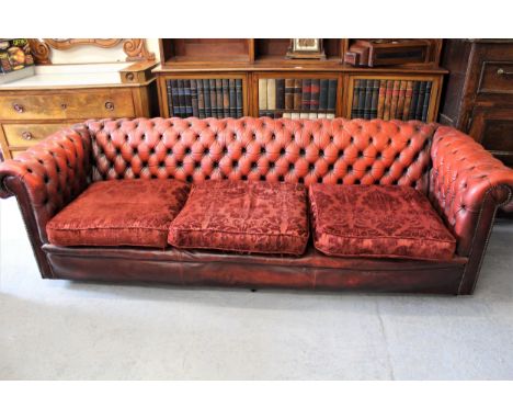 20th Century red leather upholstered Chesterfield three seat sofa, with pair of matching armchairs, having red damask upholst