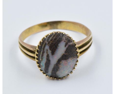 Early 20th Century gold ring set with a single oval black opal 