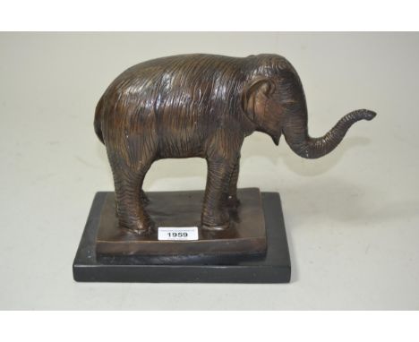 20th Century brown patinated bronze figure of an elephant, 8ins high 