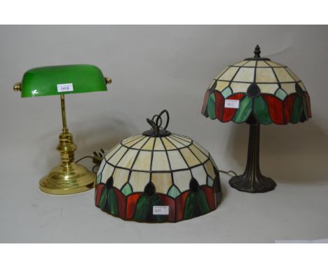 Brass desk lamp with green glass shade together with a Tiffany style hanging lampshade and a similar table lamp 