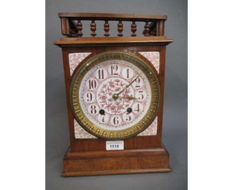 19th Century German walnut mantel clock with a spindle turned top above ceramic dial with Roman numerals, with a two train mo