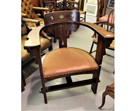 Continental Arts and Crafts walnut armchair, the shaped arms and pierced back above a padded seat on three supports, together