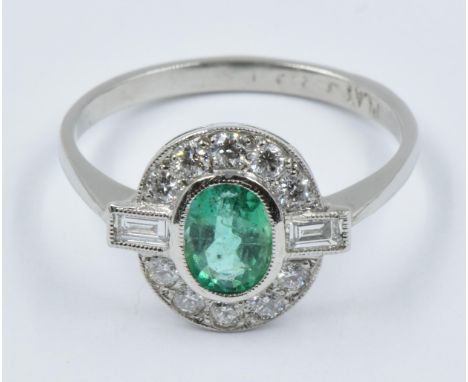 Art Deco style platinum, emerald and diamond oval cluster ringThis is a modern ring in 'as new' condition, centre stone appro