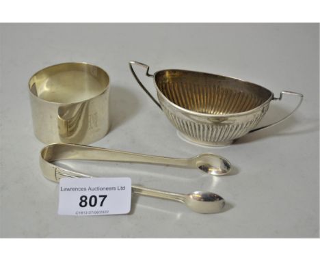 Silver napkin ring, pair of silver sugar tongs and a silver two handled salt 