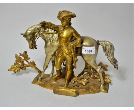 Gilt and silvered bronze figure of a man in 18th Century costume with a horse, 9ins high approximatelyFlowers on back a littl