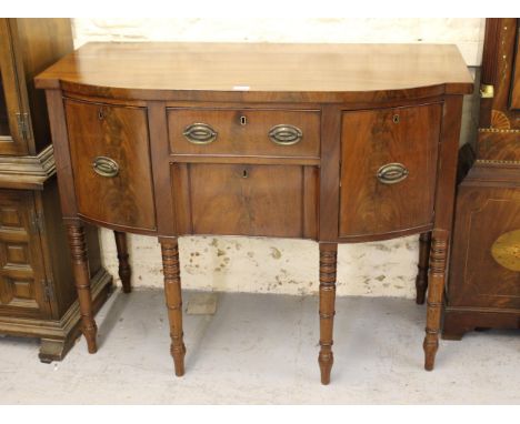 Small George III mahogany semi bow front sideboard with two central drawers flanked by two deep drawers with oval brass handl