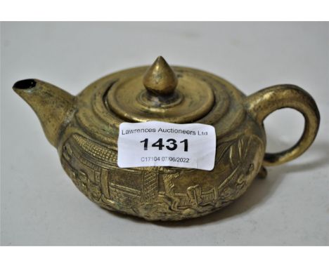 Small Chinese gilt metal teapot cast with various figures, signed with seal mark to base, 4ins diameter 