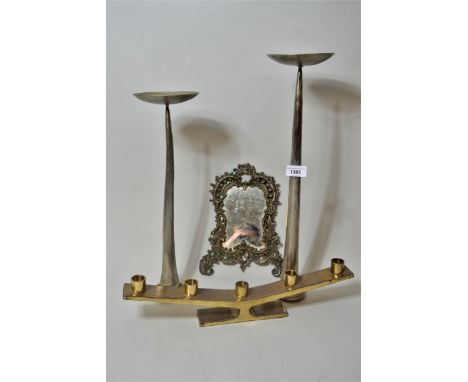 Pair of modern steel candle stands of stylised design, metal photograph frame and a brass five light candelabra 