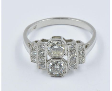 Art Deco style platinum and diamond set ring with a pair of central stones flanked by stepped diamond shoulders, approximatel