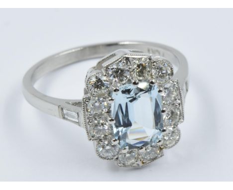 Platinum dress ring set with a single central aquamarine within a diamond surroundThis is a modern ring in 'as new' condition