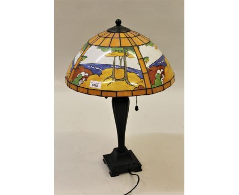 Reproduction painted metal table lamp with a leaded glass and printed shade, after Clarice Cliff designs 