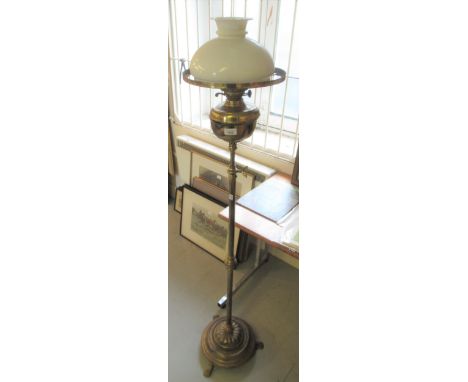 Edwardian brass oil lamp standard with opaque glass shade, together with a turned wooden standard lampBrass well is not the c