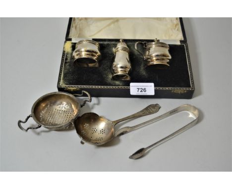 Birmingham silver three piece condiment set in fitted box, (lacking spoons), two silver tea strainers, pair of silver tongs e