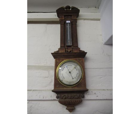 Late 19th / early 20th Century carved oak aneroid barometer thermometer by Negretti & Zambra, in architectural form case (the