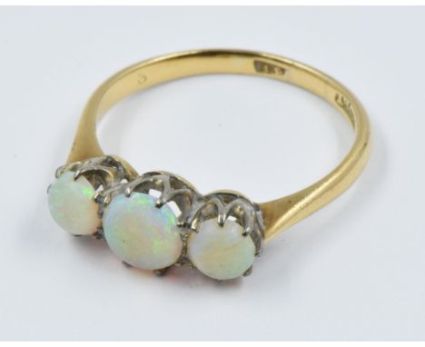 18ct Yellow gold three stone opal ringMid 20th Century ring with some signs of wear but no damage or repair. Centre stone app