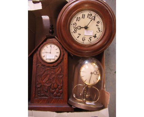 Brass anniversary clock under glass dome, circular post clock and a carved oak mantel clock 