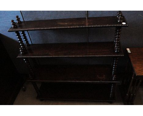 A Victorian mahogany book shelf, the four tiers on turned column supports 