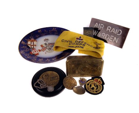 An assortment of military related items, to include a 1914 Christmas tin, Civil Defence Corps airband, Royal Marines badge, R