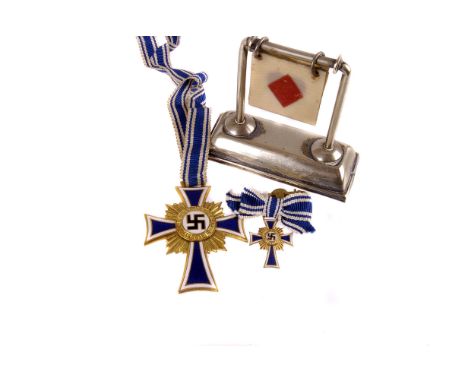 A WWII German Mutter Medal, together with miniature, plus a silver plated item (3) 