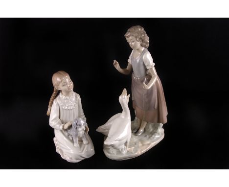 A Lladro lamp base,  modelled as a boy in bedtime dress, together with two Nao figures, (3) 