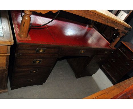 An Edwardian campaign style pedestal desk, three drawers and leather upper, with three drawers on each pedestal
153 x 77 x 74