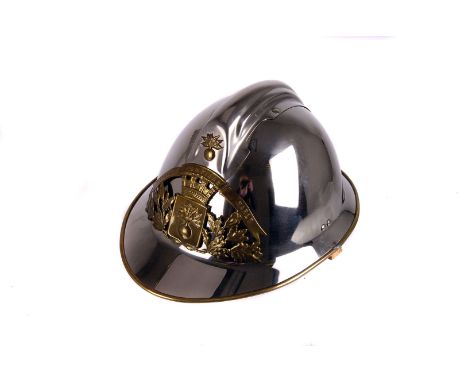A mid 20th century French Chrome fire helmet, having brass badge to front with 'Sapeurs Pompiers Marly' inscription, with lea
