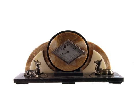 An Art Deco marble mantle clock,  the silvered kite diamond shaped dial supported on a brown marble disc, to a wing backed ma