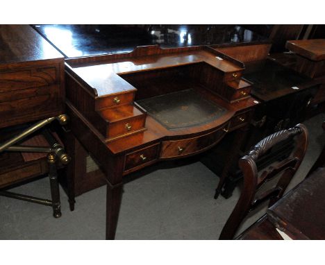 A 20th century mahogany Carlton House style desk, on four tapered supports, with three drawers to frieze, leather inset panel