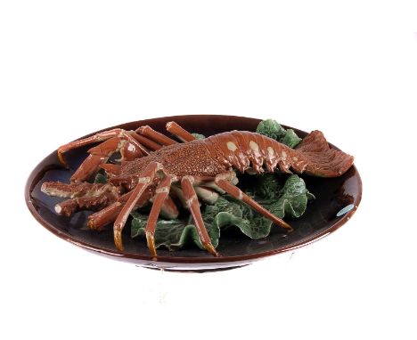 A late 19th century Palissy style majolica charger, realistically modelled as a lobster on a lettuce bed, dated 1899 verso wi