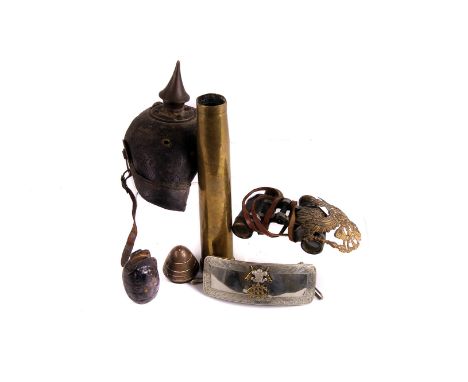 A selection of various military items, to include a picklehaube helmet, AF, field glasses, trench art, various shells, belt b