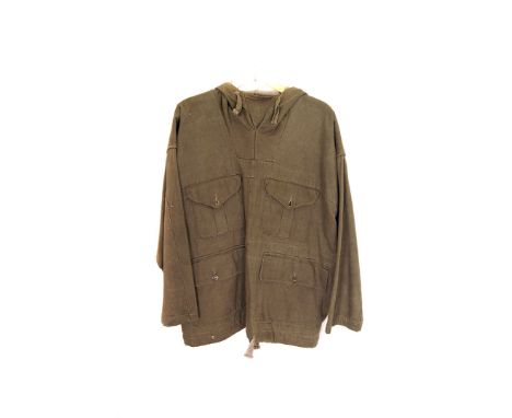 A 1950s/60s British Army hooded smock, having four pockets to front and tie string to bottom, label inside has faded complete