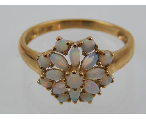 A 9 carat yellow gold and opal cluster ring. 