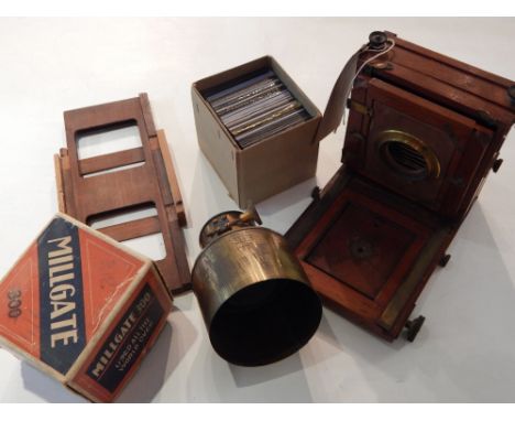 An early 20th century mahogany plate camera case, together with accessories, a magic lantern lens, slides and riding crop