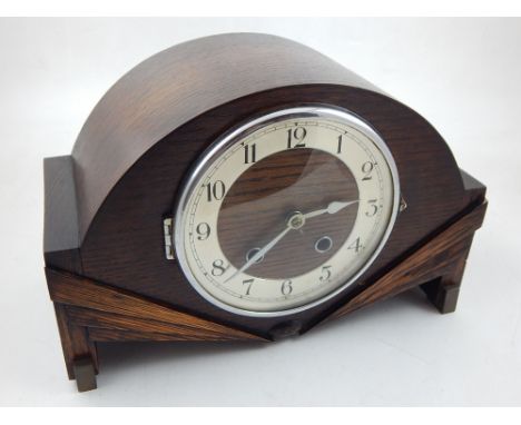 An early 20th century Art Deco oak mantel clock, eight day movement, the silvered chapter ring with Arabic numerals, chiming 
