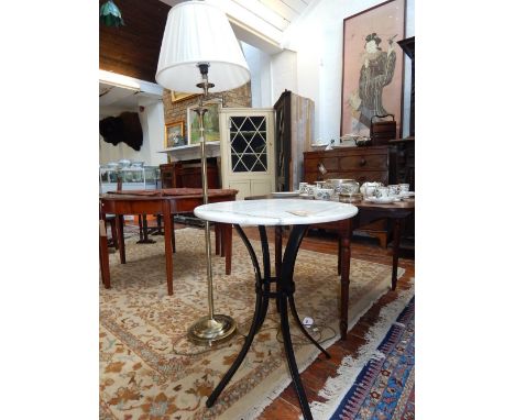 A circular marble bistro table and a modern gilt metal standard lamp.