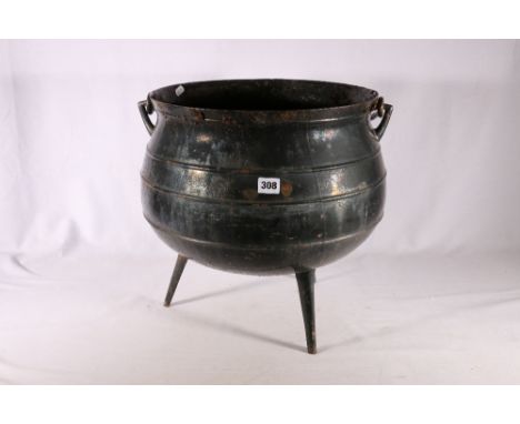 Heavy wrought iron cauldron with twist swing handle raised on three stick feet, 38cm diameter 