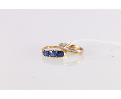 18ct gold and platinum wedding band ring, ring size J/K, 2.1g and an 18ct gold sapphire three stone dress ring, ring size M, 