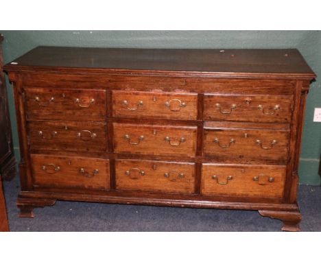 Antique oak sideboard, the crossbanded top with moulded edge above an arrangement of cupboards and drawers raised on squat og