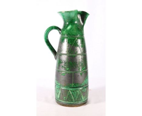 Arts and Crafts pottery pitcher or ewer with green lustre glaze and sgraffito decoration, 37cm tall 